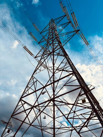 A high voltage power line against a blue sky